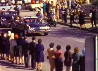 President John F. Kennedy's motorcade traveling through Dealey Plaza in Dallas, Texas, on November 22, 1963.